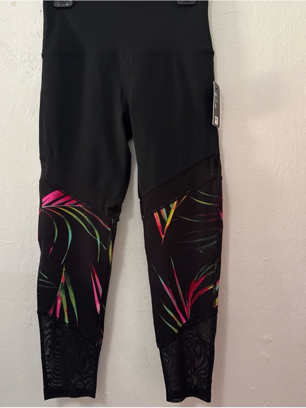 BSP black leggings with multicolored leaf print on the lower legs, size L.